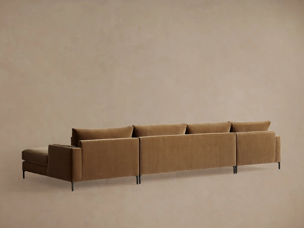 Brown upholstered Sumner Three-Piece Double Chaise Sectional, close-up of smooth fabric, showing seat cushion and backrest detail.