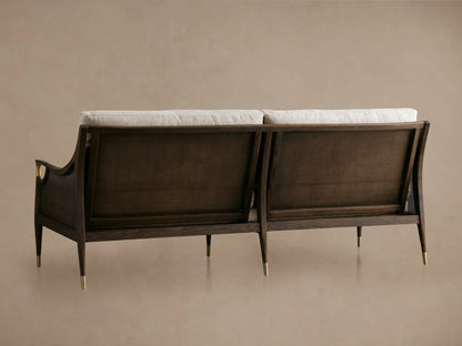 Fisher Cane Back Sofa with red oak wood frame in mocha finish, cane backrests, and white cushions, viewed from the back.