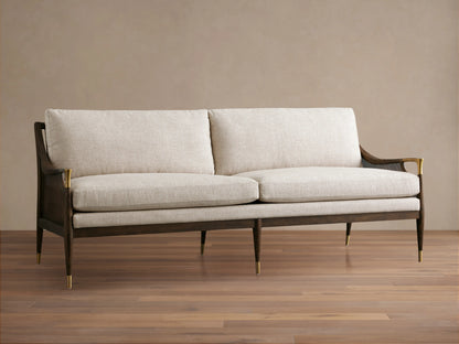 Fisher Cane Back Sofa in a mocha-finished red oak frame with beige cushions, gold accents, and tapered legs on a wooden floor.