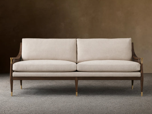 Fisher Cane Back Sofa with beige cushions. Crafted from red oak wood in mocha finish, features cane detailing and slender legs.