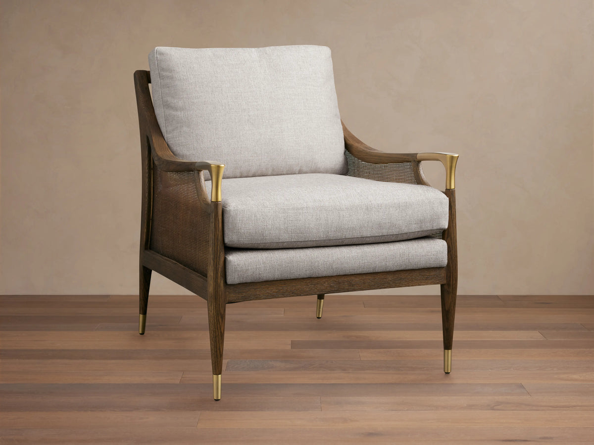 Fisher Cane Back Chair with a mocha-finished red oak frame, light gray cushioned seat and back, gold-tipped legs on wood floor.