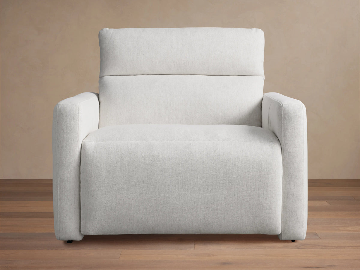 Light grey Rowland Tailored High-Back Motion Recliner, angled left, textured fabric, on wood floor.