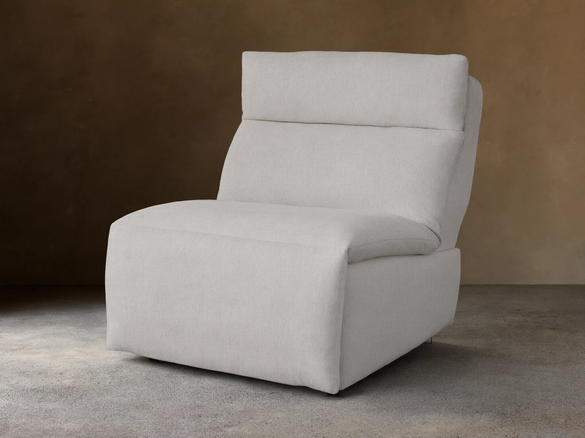 Rowland Tailored 34" Armless Motion Recliner, light grey tailored fabric, plush cushions, angled right on wood floor.