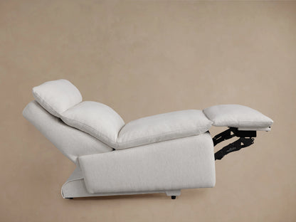 Rowland Tailored Armless Motion Recliner close-up. Off-white textured fabric, showing seat cushion, backrest, and silver control buttons.