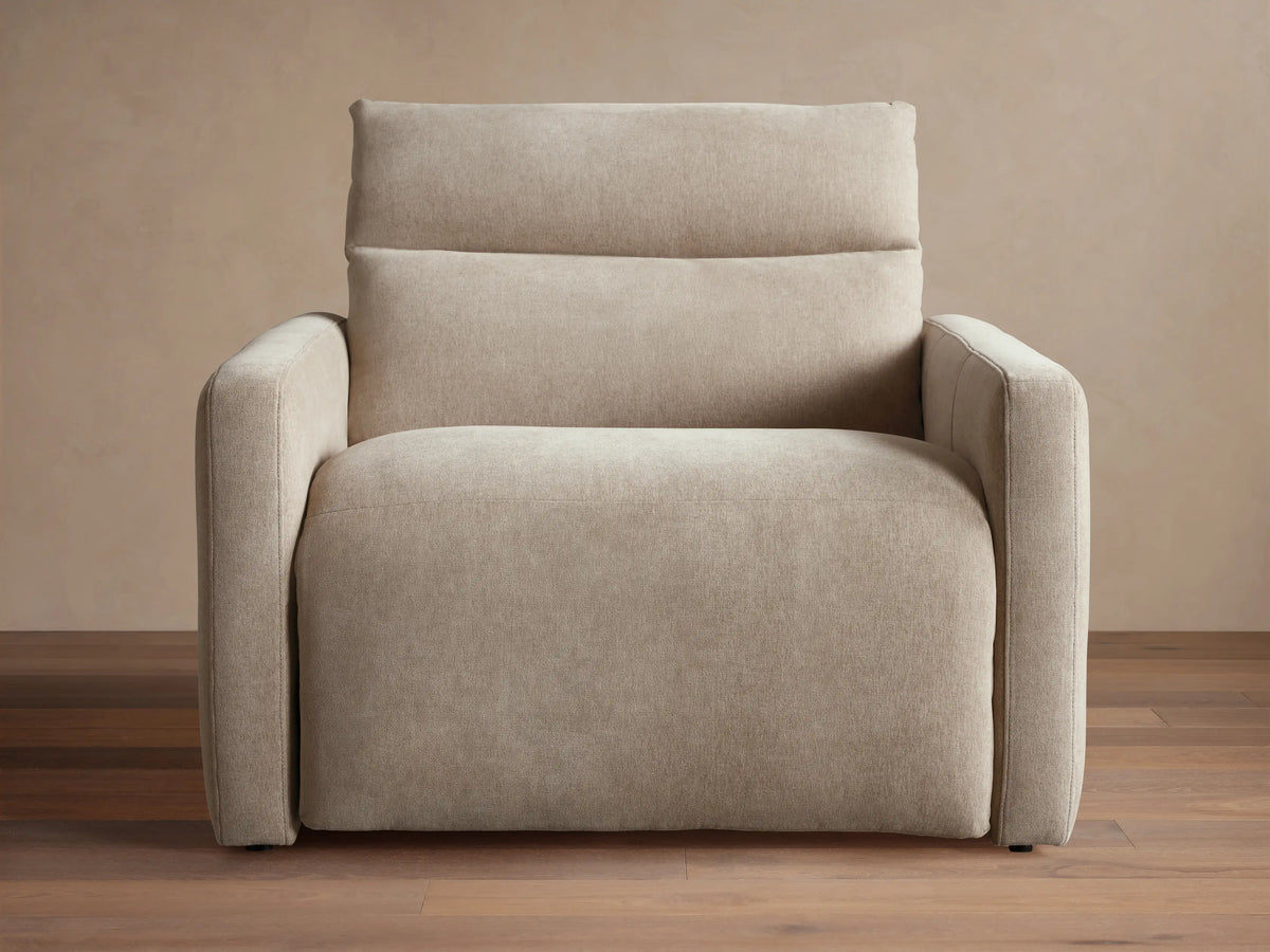 Rowland Tailored High-Back Motion Recliner in light beige woven fabric, shown from front with clean lines on wood floor.
