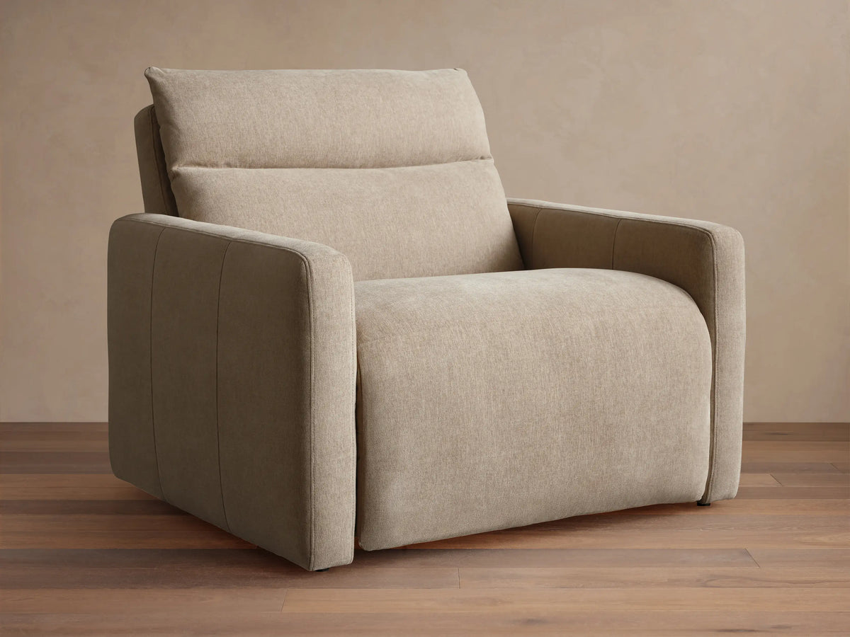 Rowland Tailored High-Back Motion Recliner in light beige woven fabric, shown from front with clean lines on wood floor.