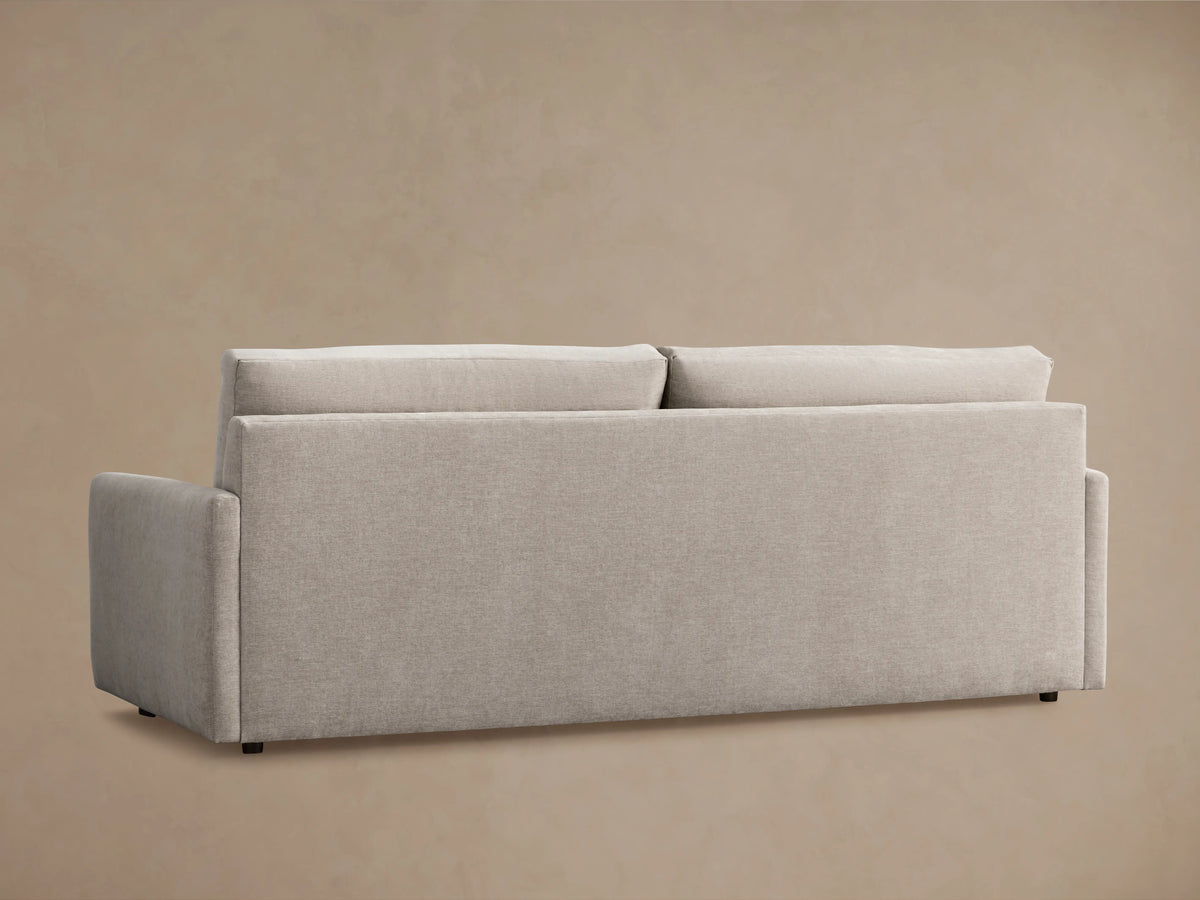 Kipton Sofa in beige fabric, showcasing a plush seat cushion and armrest with clean, modern lines against a neutral background.