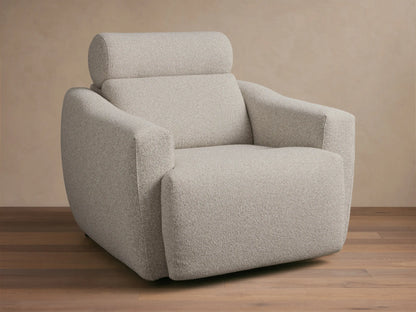 Front-quarter view of a light grey textured Fia Motion Recliner with wide arms and a padded headrest.