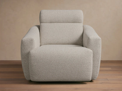 Front-quarter view of a light grey textured Fia Motion Recliner with wide arms and a padded headrest.