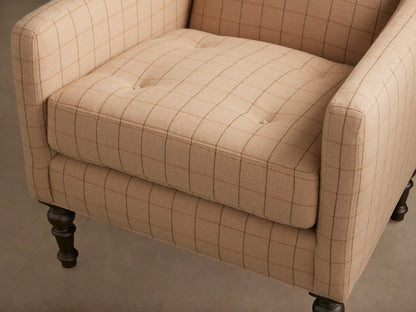 Fenwick Chair in beige fabric with a subtle grid pattern, featuring a cushioned seat and elegantly turned wooden legs on a hardwood floor.
