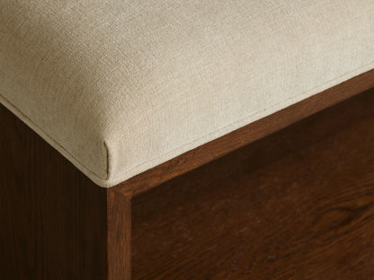 Taya Bench: Rectangular bench with light cream upholstered seat and open mocha brown wood frame base, viewed head-on.