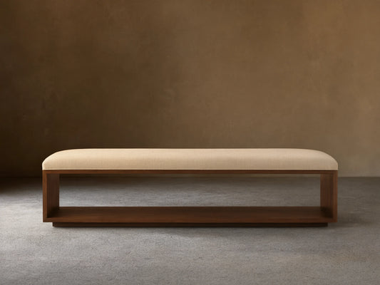 Taya Bench: Rectangular bench with light cream upholstered seat and open mocha brown wood frame base, viewed head-on.