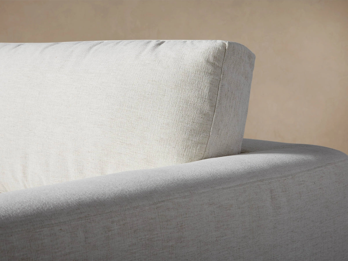 Beale Five-Piece Corner Sectional close-up, showing light neutral-colored, textured fabric on seat, back cushions & armrest.