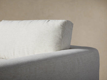 Close-up of Beale Four-Piece Sectional in light gray fabric. Plush seat, back cushions, and squared armrest show casual comfort.