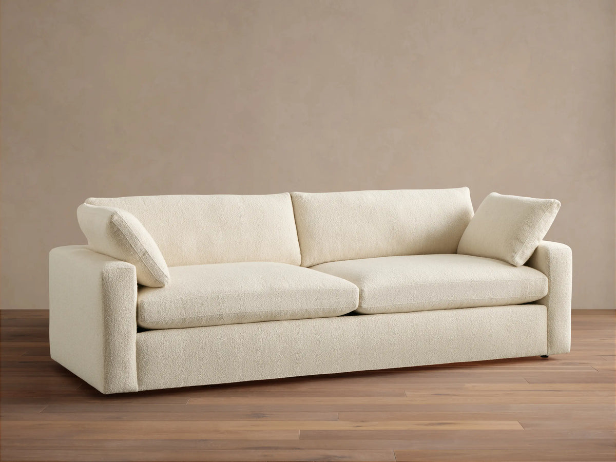 Beale Sofa, off-white textured fabric, front view. Two large seat cushions, two back cushions, and two small arm pillows.