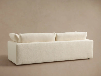 Close-up of off-white Beale Sofa with a textured, nubby fabric. Shows the wide armrest, seat, and back cushion details from an angle.