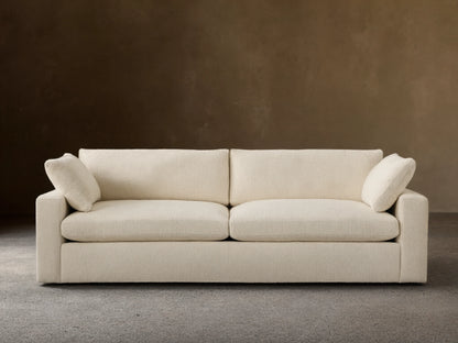 Beale Sofa, off-white textured fabric, front view. Two large seat cushions, two back cushions, and two small arm pillows.