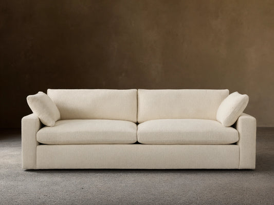 Beale Sofa, off-white textured fabric, front view. Two large seat cushions, two back cushions, and two small arm pillows.