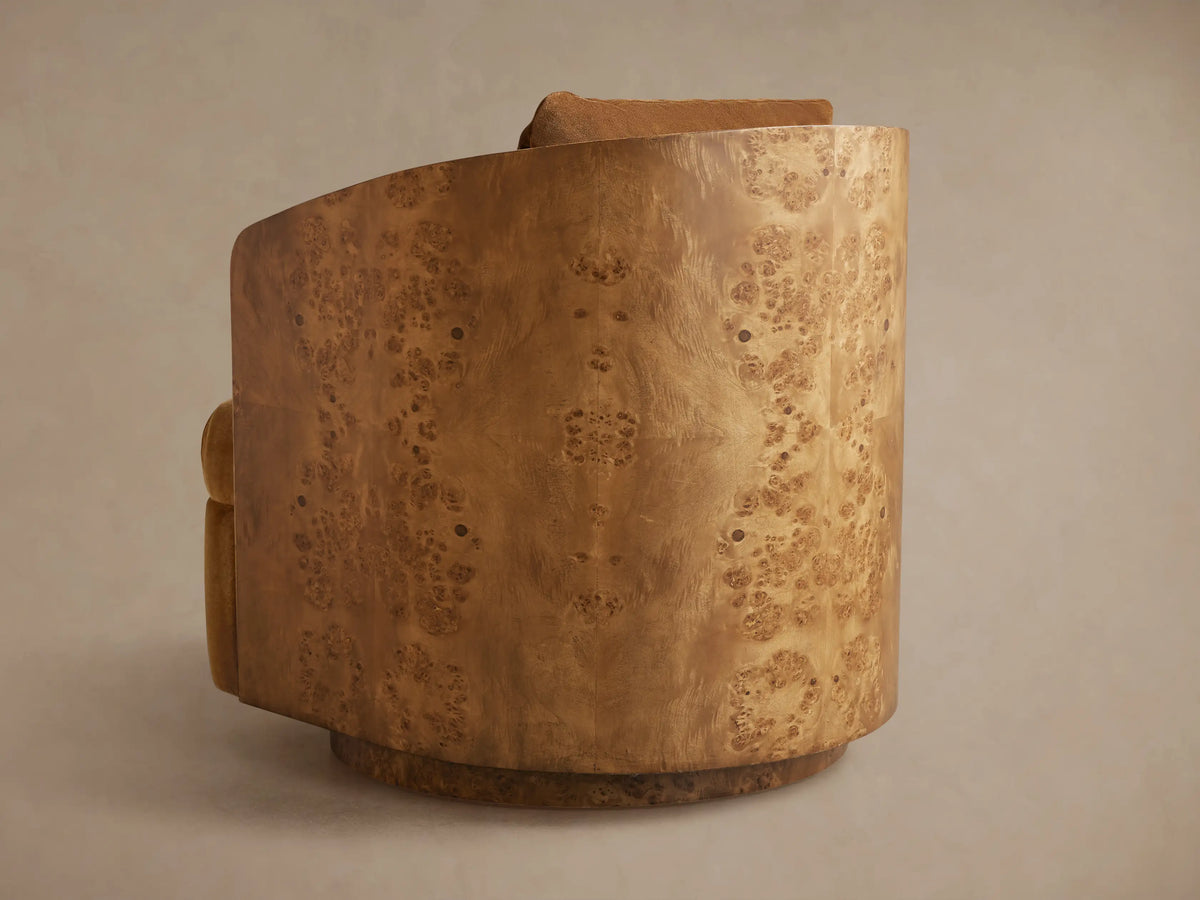 Tilda Swivel Chair, back 3/4 view. Curved wooden frame with unique burl veneer pattern in light brown, warm brown fabric visible.