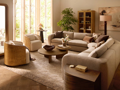 Angled Tilda Swivel Chair, cream boucle upholstery, curved burl wood frame & base, with a matching back cushion.