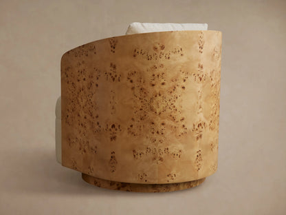 Side view of Tilda Swivel Chair with curved light brown burl wood back and subtle mottled grain, light upholstered cushion.