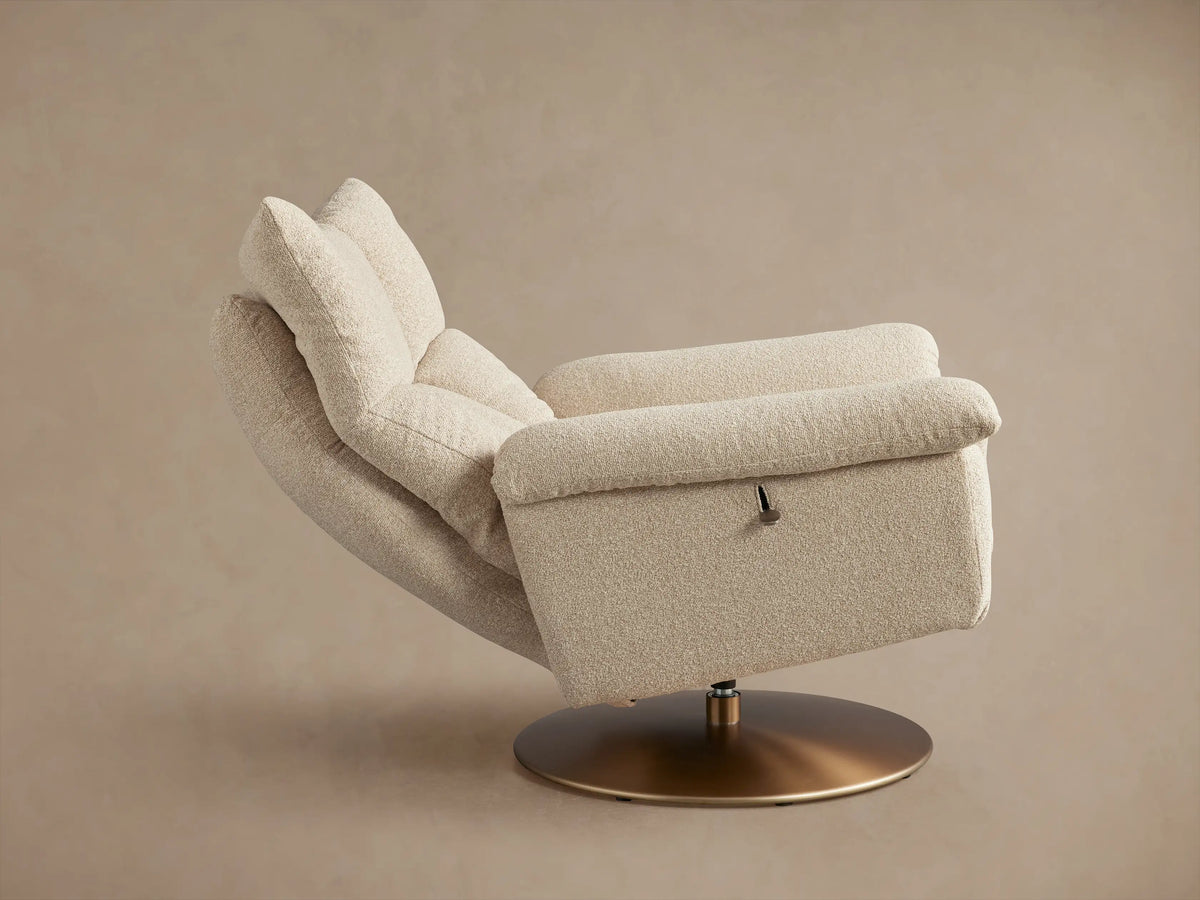 Deacon Swivel Recliner in beige fabric, showing its plush, quilted backrest and armrests, with textured upholstery against a neutral background.