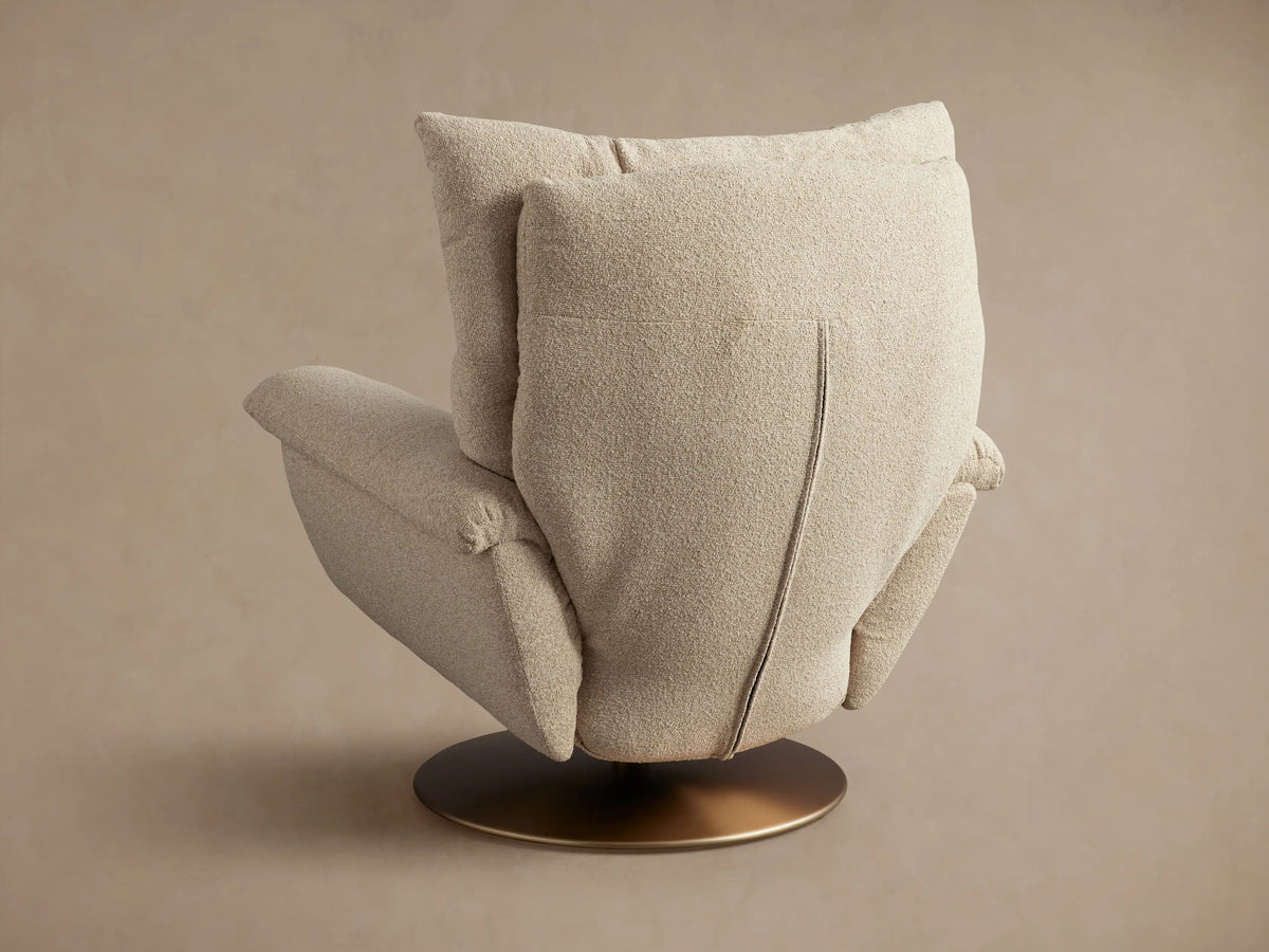 Deacon Swivel Recliner in beige fabric, shown reclined at an angle with a side lever, on a round, bronze swivel base.