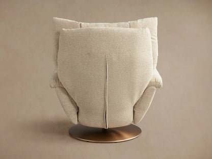 Deacon Swivel Recliner in neutral fabric shown from back view with overstuffed cushion, wide armrests, and round bronze swivel base.