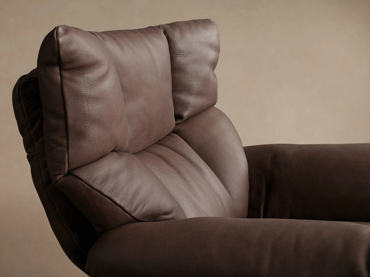 Deacon Leather Swivel Recliner in brown leather, features a side lever and plush cushioned armrest, set against a neutral background.