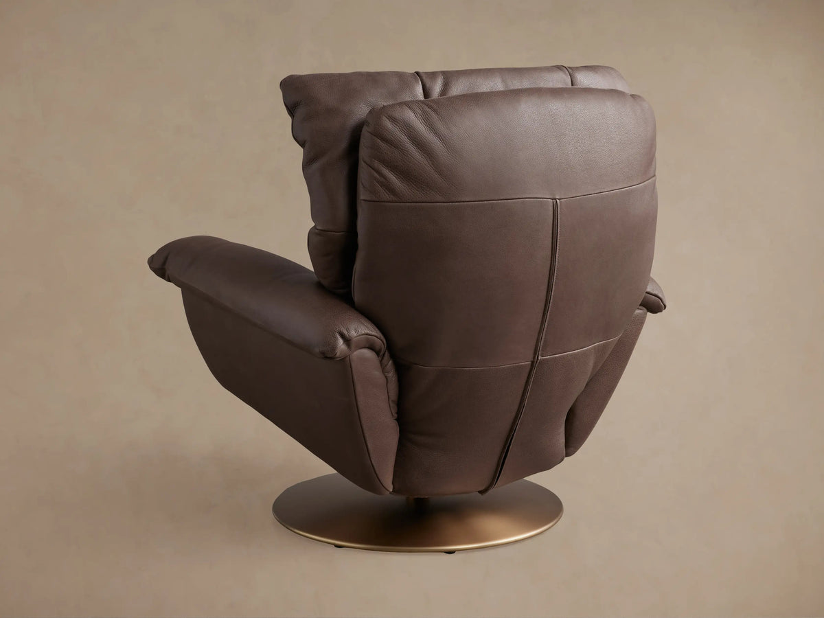 Deacon Leather Swivel Recliner in dark brown, shown in a reclined position with cushioned backrest and a gold swivel base.