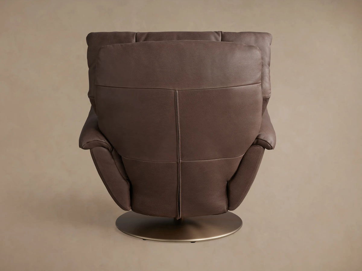 Deacon Leather Swivel Recliner in brown leather, rear view. Features plush cushioning and a bronze circular base.