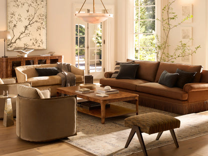 Front view of the Nataly Swivel Chair with cream and olive textured upholstery and an exposed light brass frame.