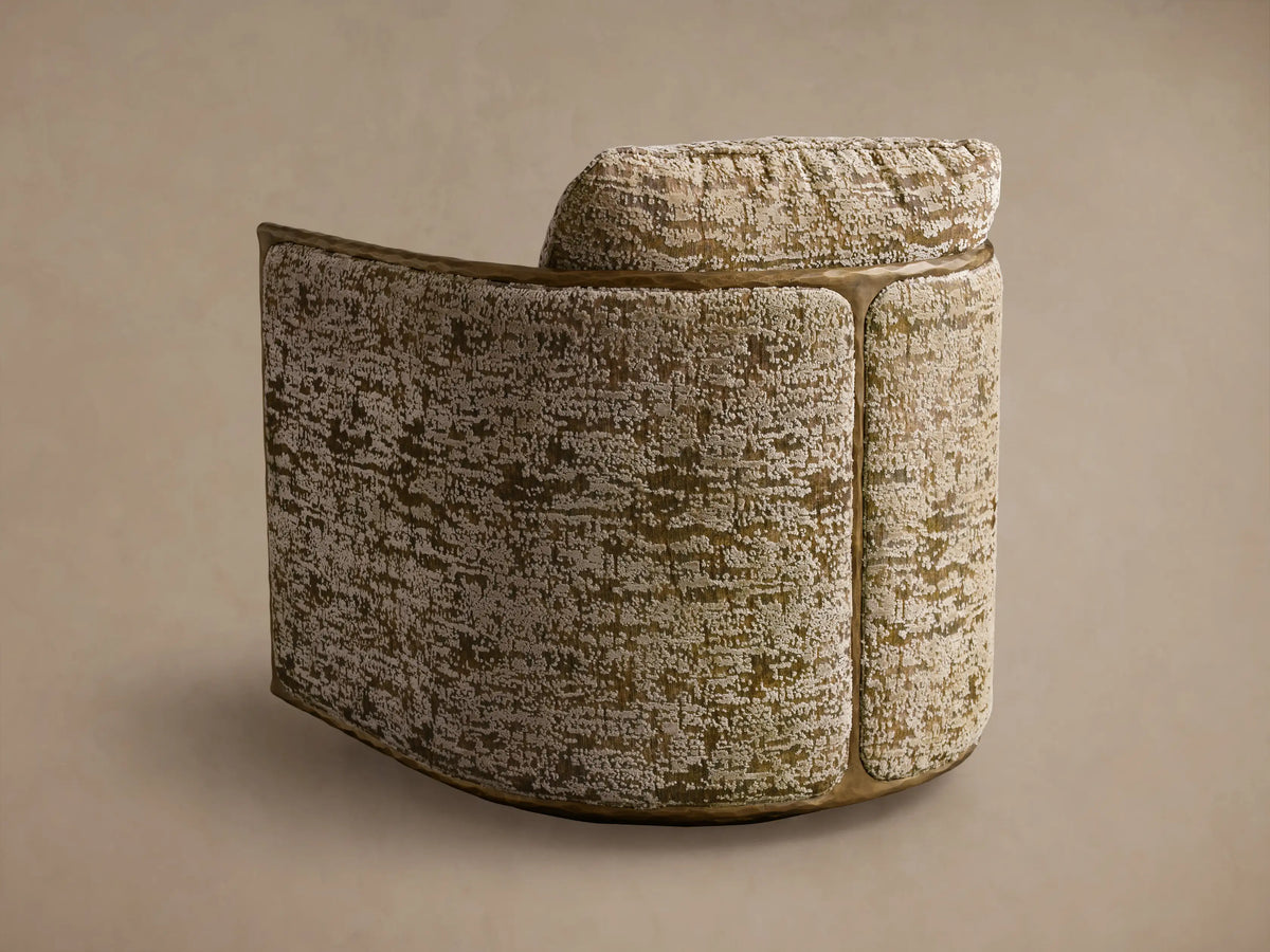 Close-up of the Nataly Swivel Chair, showing its textured olive green and cream fabric with hammered light brass trim.