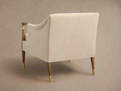 Front view of cream Fisher Club Chair with tufted back, dark wood arms and legs with brass accents, includes matching lumbar pillow.