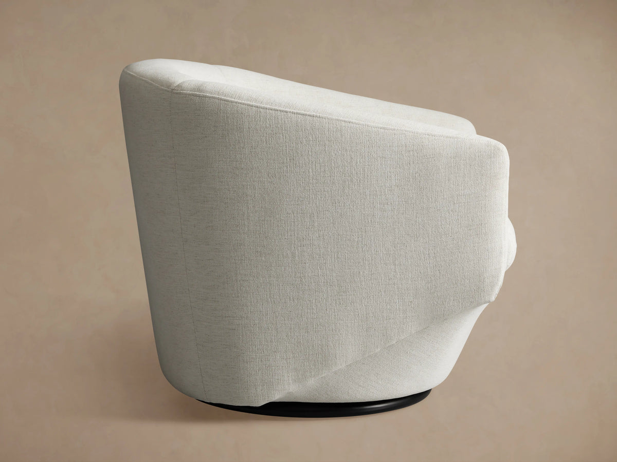 Pelton Swivel Chair with light beige fabric, showcasing curved armrests and plush seat cushion, against a neutral background.