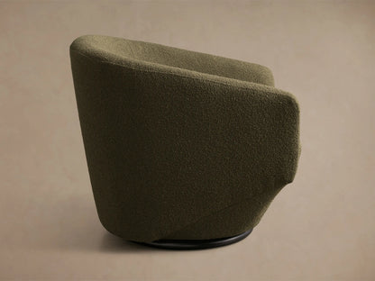 Side profile of the olive green Pelton Swivel Chair, showing its textured fabric and black circular swivel base.