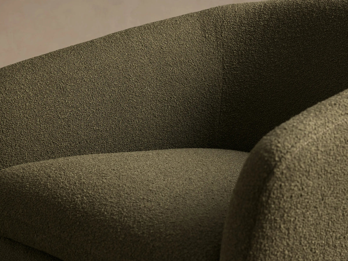 Front view of a forest green textured Pelton Swivel Chair, with a deep seat, curved arms, and a black round swivel base.