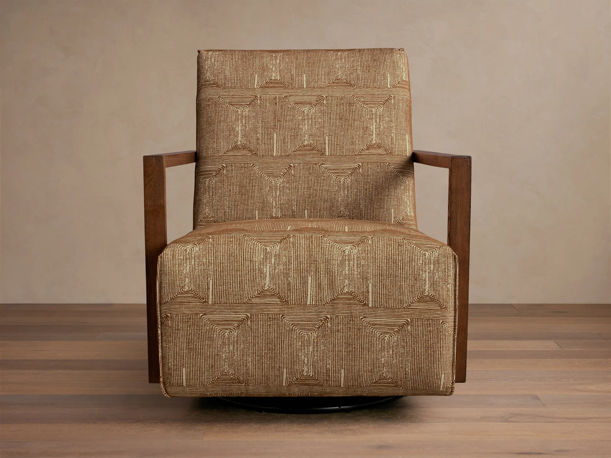 Front view of the Walsh Swivel Glider with tan geometric patterned upholstery, dark wooden armrests, and a black swivel base.