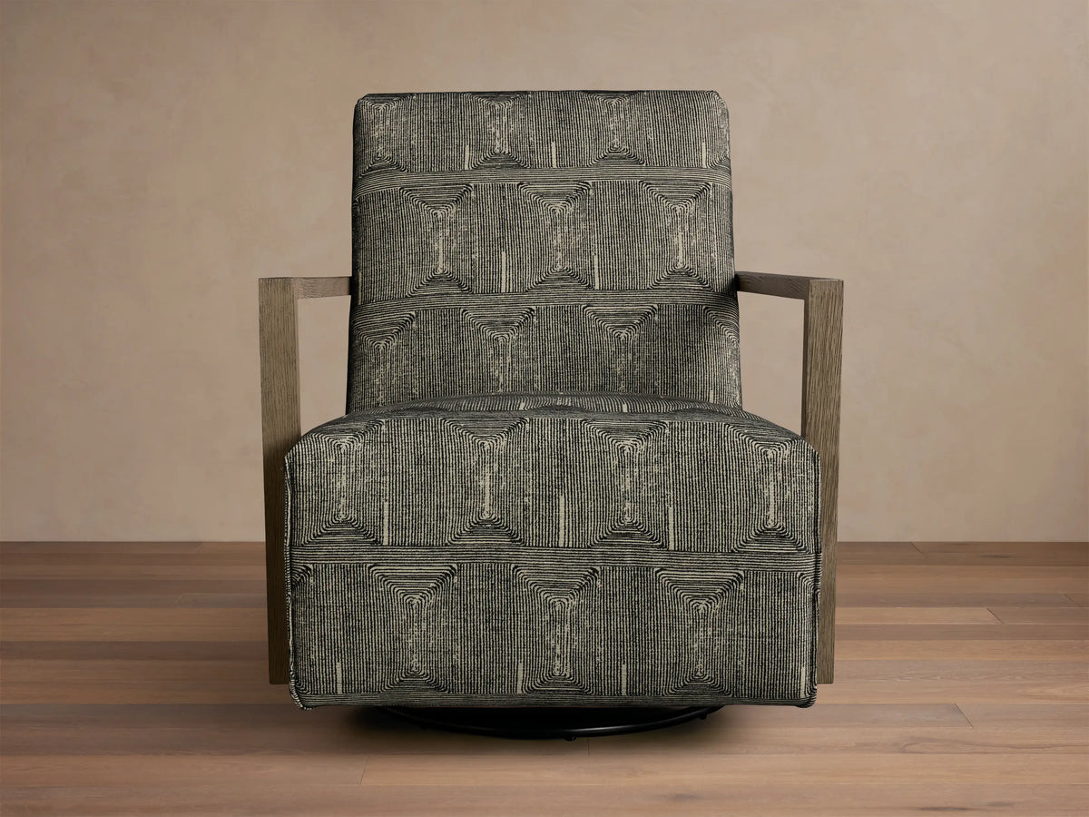 Front view of the charcoal geometric line pattern Walsh Swivel Glider with light wood arms and a black swivel base.