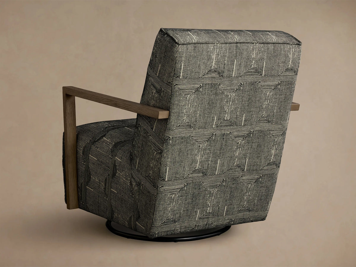 Close-up of the Walsh Swivel Glider's light brown wooden armrest, with black and off-white linear patterned fabric cushions.