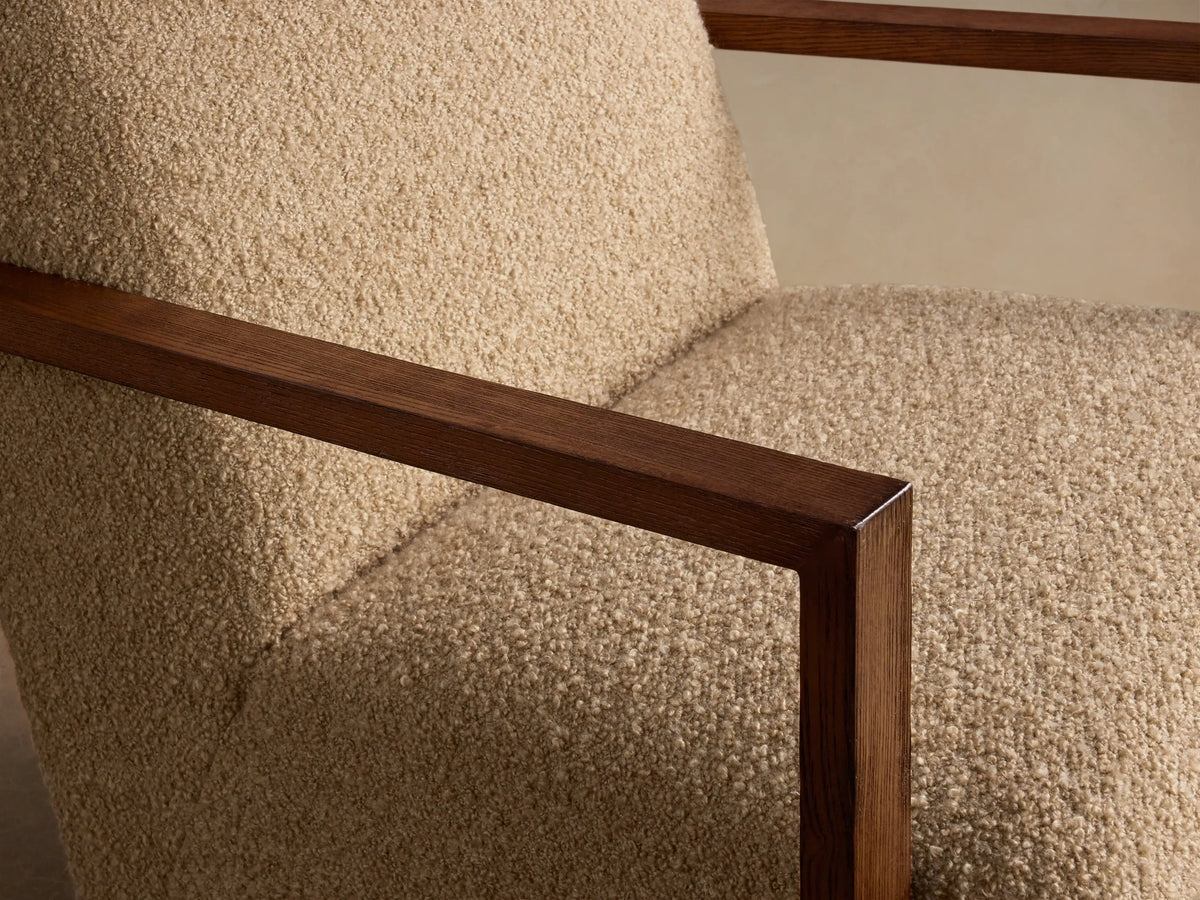 Front view of the Walsh Swivel Glider, featuring beige bouclv© upholstery and exposed dark wood armrests.