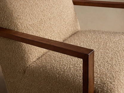 Front view of the Walsh Swivel Glider, featuring beige bouclv© upholstery and exposed dark wood armrests.