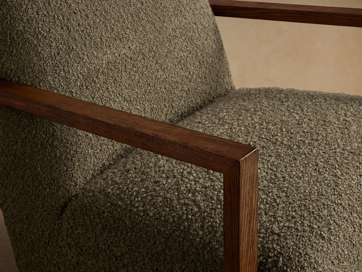 Front view of the olive green textured Walsh Swivel Glider with dark wooden armrests and a black swivel base.