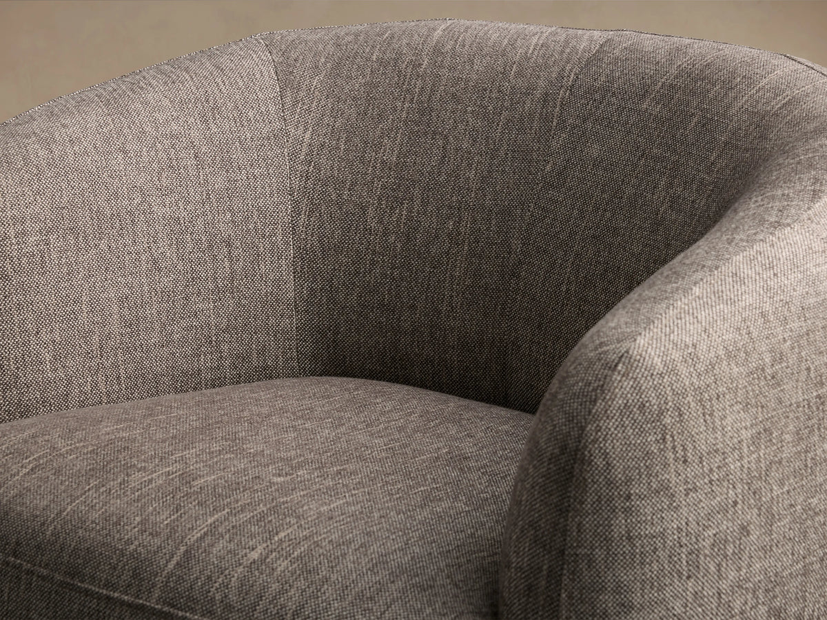 Cerrito Swivel Chair in gray fabric, featuring curved backrest and cushioned seat, on a wooden swivel base, set against a wood floor.