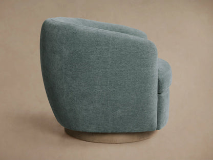 Close-up of a Cerrito Swivel Chair's curved backrest and seat, upholstered in textured greenish-blue fabric.