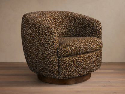 Front-right view of the brown leopard print Cerrito Swivel Chair, featuring a rounded barrel shape and a dark wood swivel base.