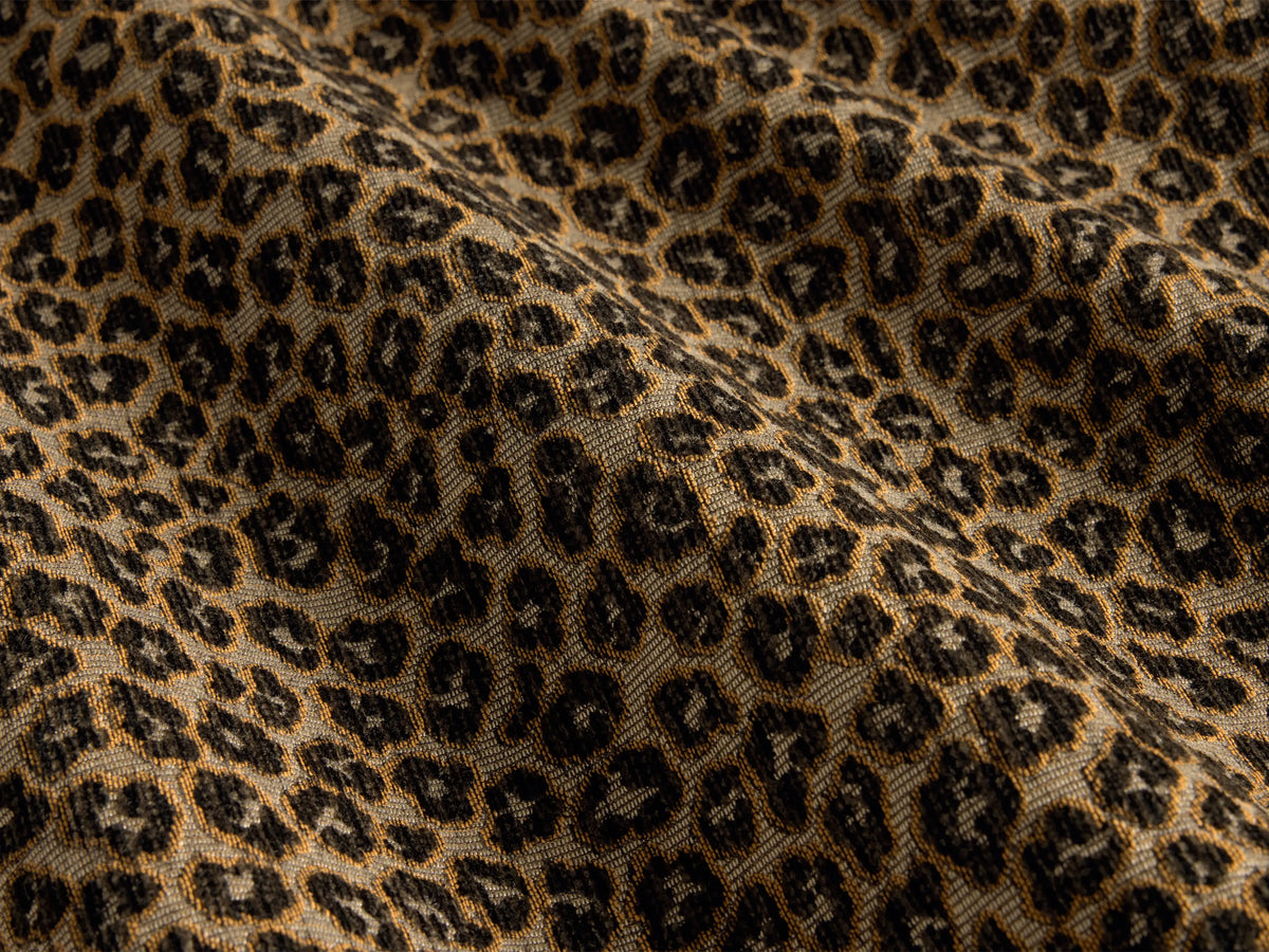 Close-up of the taupe, black, and tan leopard print jacquard weave fabric on the Cerrito Swivel Chair.