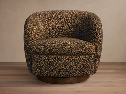 Front view of the Cerrito Swivel Chair in tan and black leopard print, featuring a rounded shape and dark wooden swivel base.