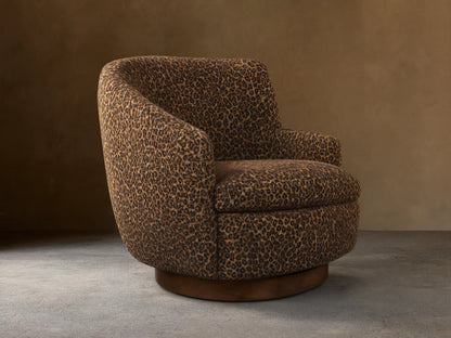 Front-right view of the brown leopard print Cerrito Swivel Chair, featuring a rounded barrel shape and a dark wood swivel base.