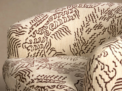 Front view of the Cerrito Swivel Chair in off-white fabric with a brown abstract pattern, featuring a rounded back and wooden swivel base.
